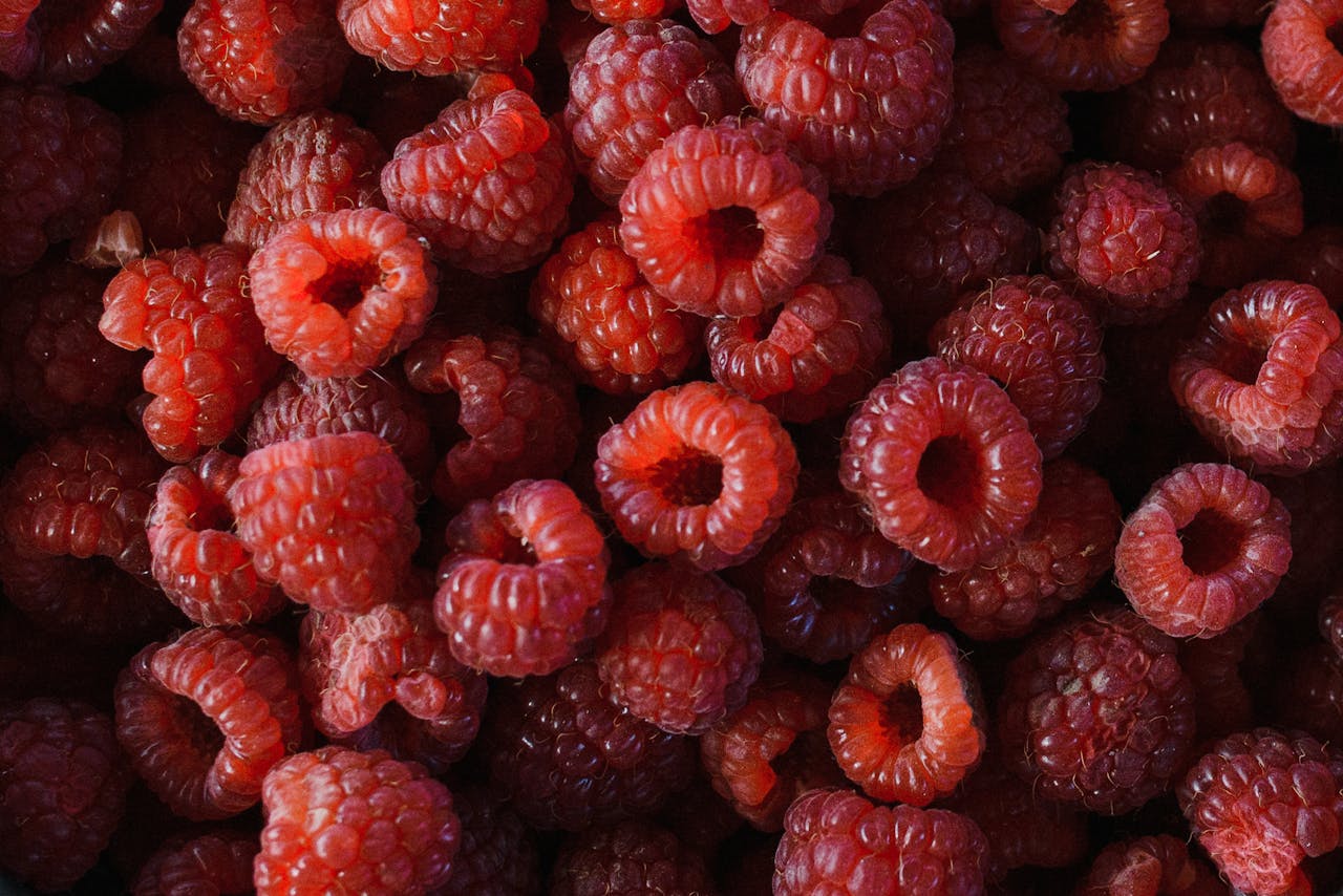 Vibrant top view of fresh organic raspberries, highlighting their rich red color.